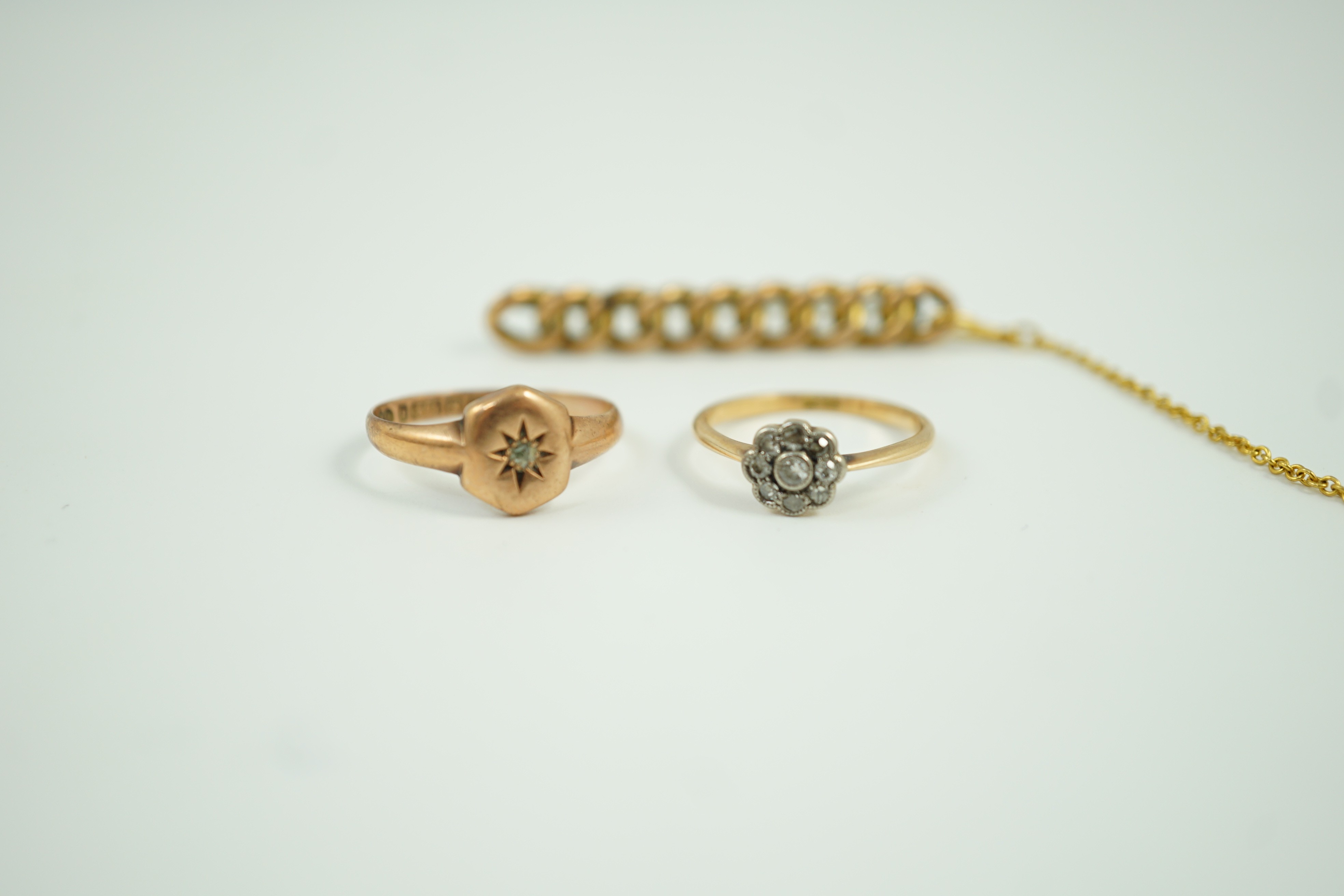 A small 18ct and diamond set cluster ring, size K, gross 1.2 grams, a 9ct gold and diamond chip set ring and a yellow metal curb link bar brooch, gross 5.1 grams.